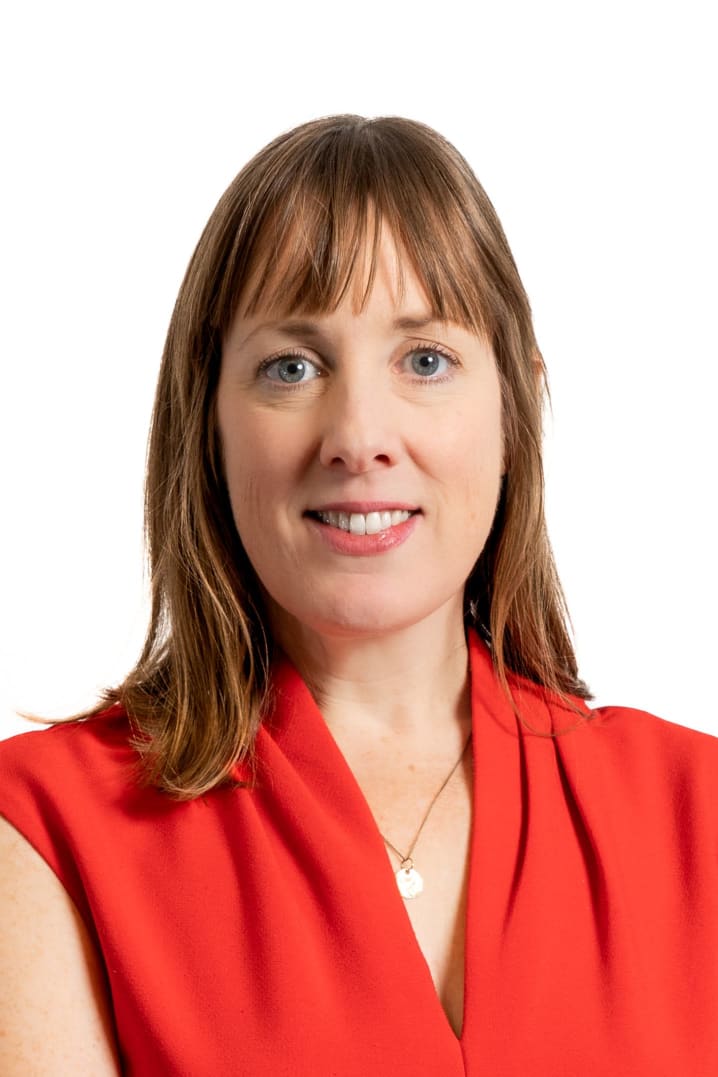Amy MacLaren, Director of External Relations; portrait photo of woman with light brown hair smiling at the camera wearing a red top