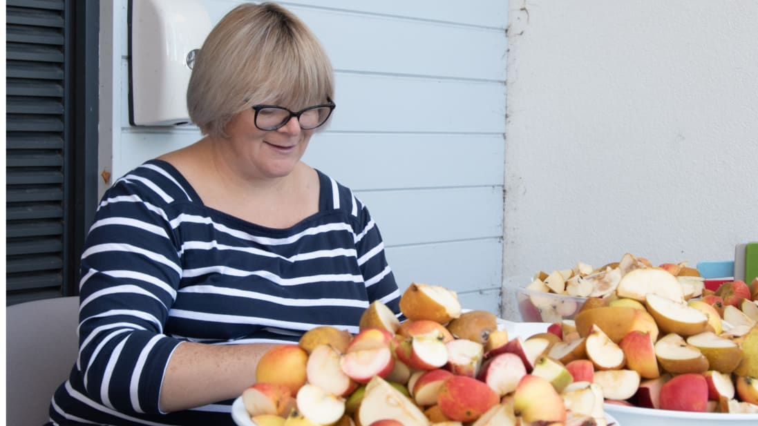 A woman peeling apples